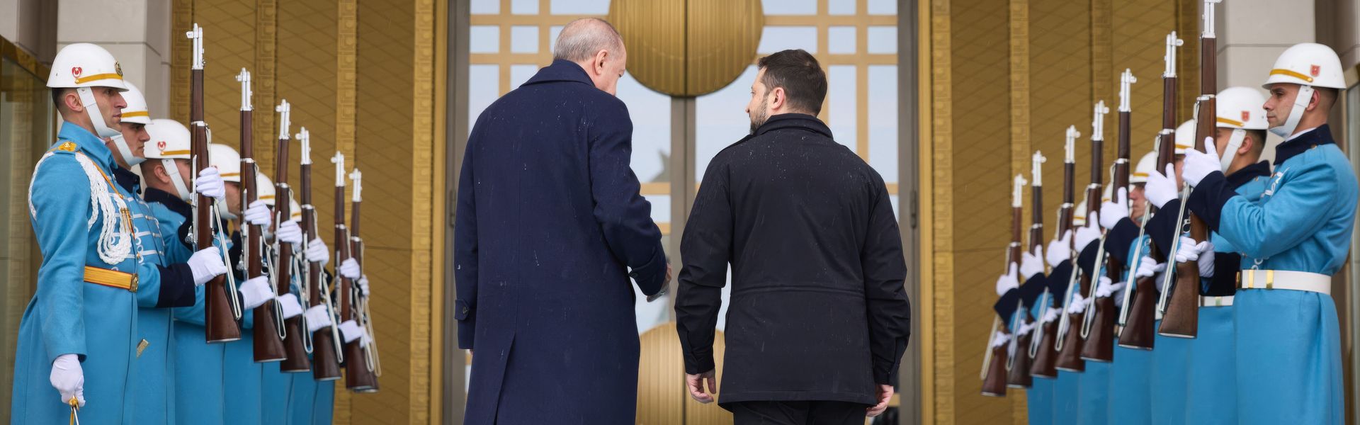 Ukrainian President Volodymyr Zelenskyy is escorted by Turkish Prime Minister Recep Tayyip Erdogan upon arriving for a bilateral meeting at the Presidential Palace in Ankara on February 18, 2025.